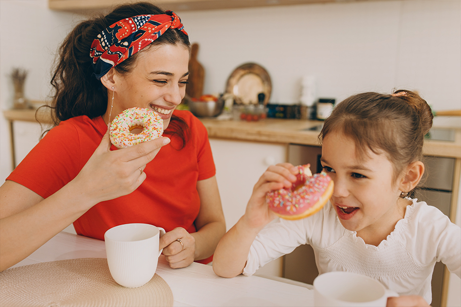 A mom and her family eating doughnuts