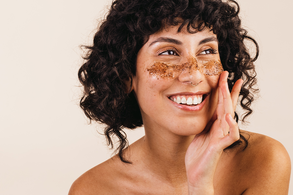 Woman applying a sugar scrub to her skin