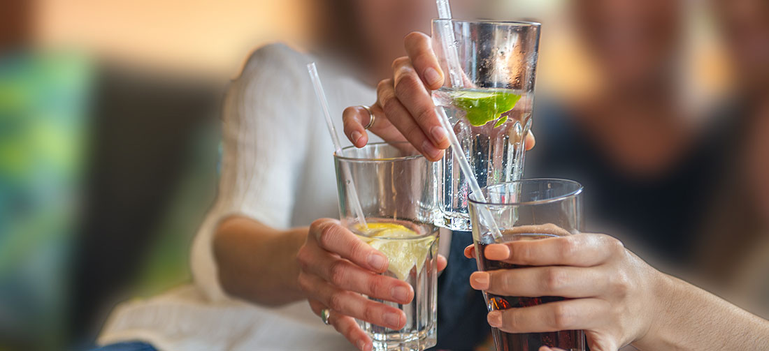 A group of friends make a toast with non-alcoholic drinks.