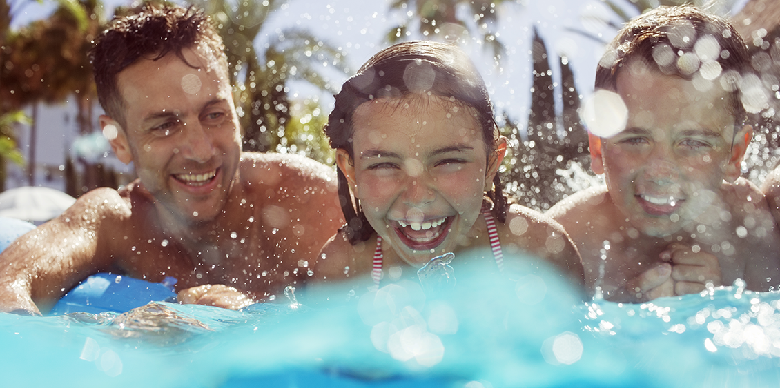 A little girl in vacation is swimming underwater with her mother.