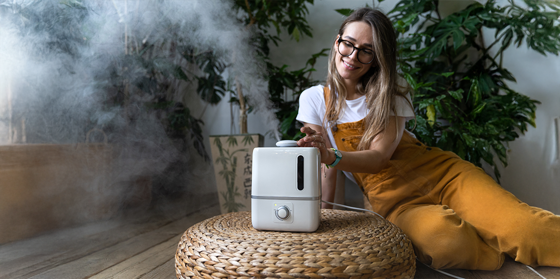A woman uses a humidifier in her home