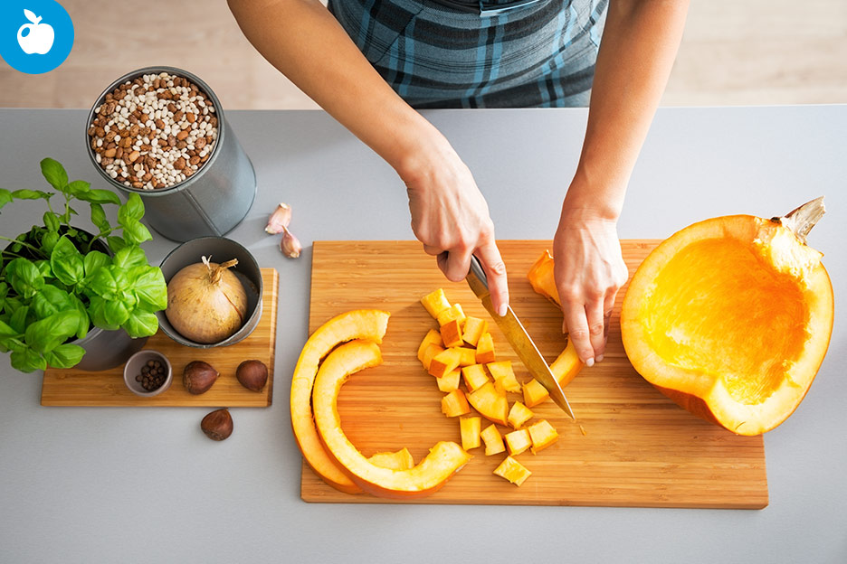 A person preparing seasonal vegetables in the fall and winter.