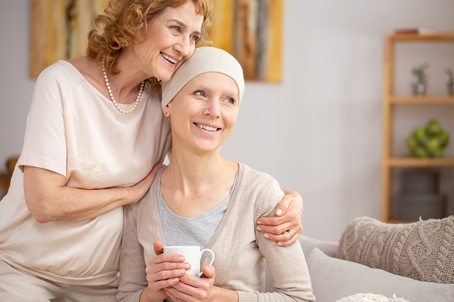 Woman cheering up her friend who is coping with cancer