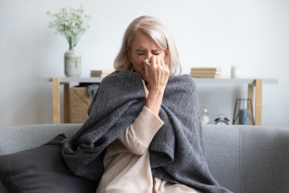 A woman blows her nose