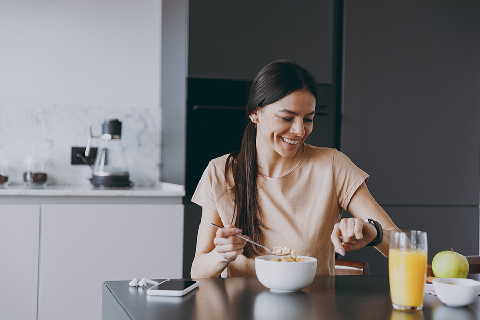 Woman eating a balanced breakfast after physical activity.